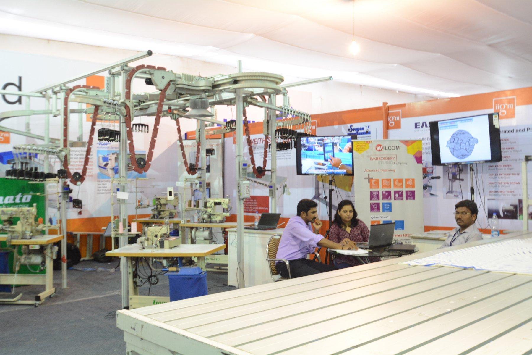 Garment station machine and CAD/CAM system on the show floor.