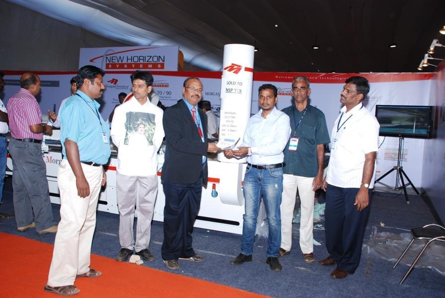 Dignitaries at a stall visit.